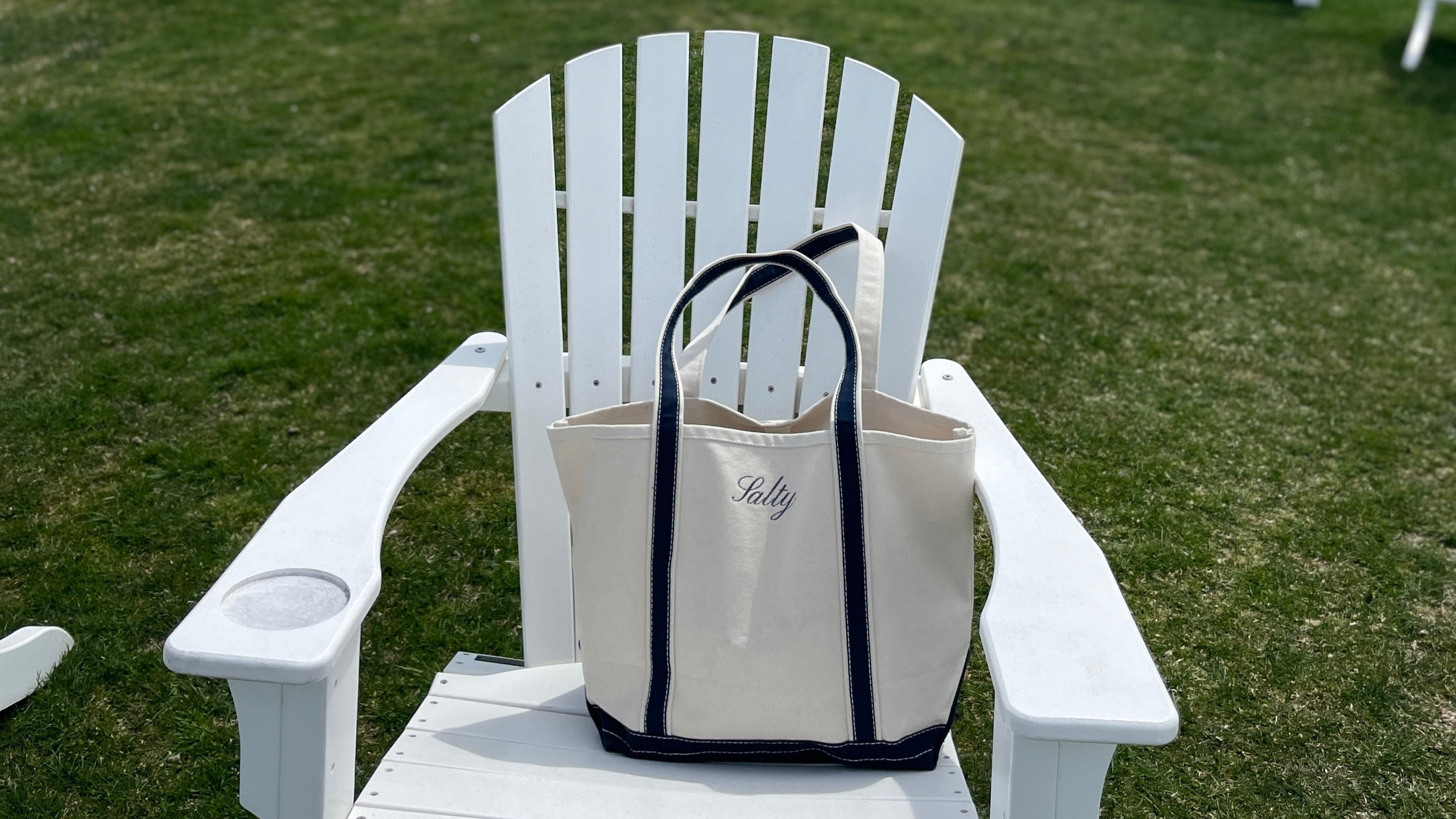 Personalized navy tote bag on white Adirondack chair Newport